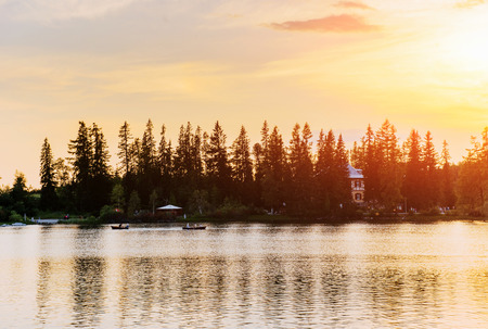 Sunset over the lake. Majestic mountain lake in National Park High Tatra. Strbske pleso, Slovakiaの写真素材