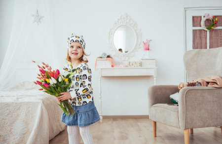 Happy girl with flowers in their handsの写真素材