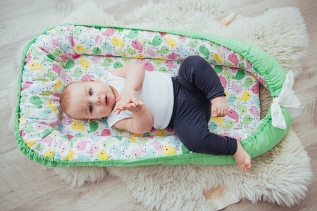 Bedding for children. The baby sleeps in bed. A healthy little baby soon after birth.の写真素材