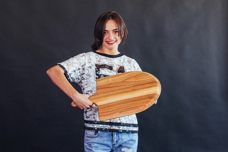 Beautiful young woman with a wooden boardの写真素材