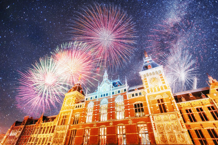 Beautiful calm night view of Amsterdam city. Colorful fireworks on the black sky background. Photo greeting card. Bokeh light effect, soft filter.の写真素材