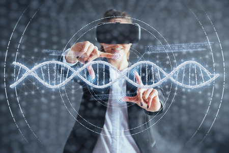 Happy woman on a black background in the studio gets the experience of using VR-glasses virtual reality headset. Innovative technologies in science and medicine.の写真素材