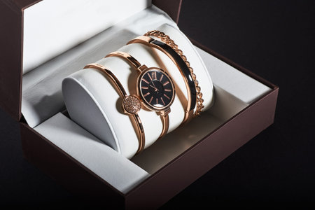 Golden woman watch on a white background in the box.