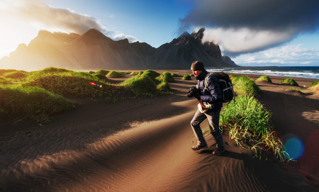 Fantastic west of the mountains and volcanic lava sand dunes to the beach Stokksness. Tourists traveling through the wilderness. Icelandの写真素材