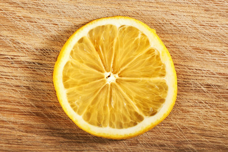 a slice of lemon, isolated on a wooden backgroundの写真素材