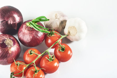blue onion garlic and tomato isolated on white backgroundの写真素材