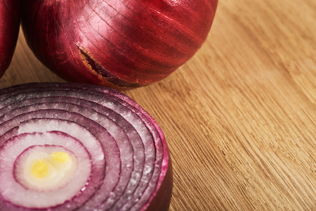 Half red onion on a wooden backgroundの写真素材