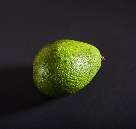 Fresh delicious avocado isolated on a black background