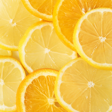 slices of orange and lemon isolated on a white background.の写真素材