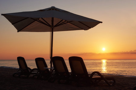 Scenic view of sandy beach on the beach with sun beds and umbrellas open against the sea and...