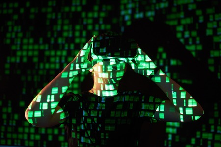 Double exposure of a caucasian man and Virtual reality headset is presumably a gamer or a hacker cracking the code into a secure network or server, with lines of codeの写真素材