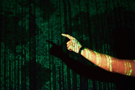 Double exposure of a caucasian man and Virtual reality VR headset is presumably a gamer or a hacker cracking the code into a secure network or server, with lines of codeの写真素材