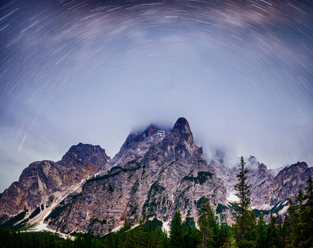 Fantastic starry sky. Autumn landscape and snow-capped peaks. Main Caucasian Ridge. Mountain View from Mount Ushba Meyer, Georgia. Europe.の写真素材