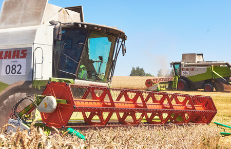TERNOPIL - JULY 20: A modern combine harvester working a wheat field on July 20, 2017, in Ternopil.のeditorial素材