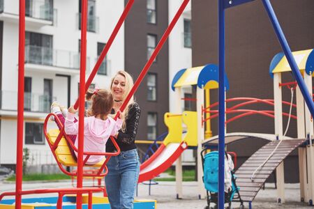 mother with child on the playgroundの写真素材
