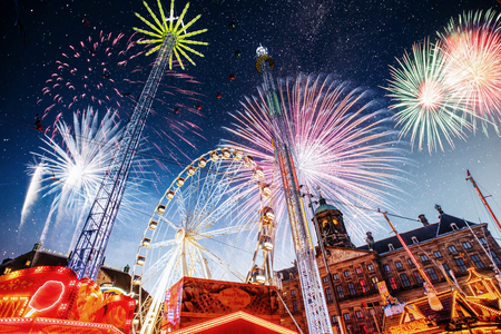 amusement park at the center of Amsterdam at night. Beautiful starry sky, majestic fireworks on the nightlife.の写真素材