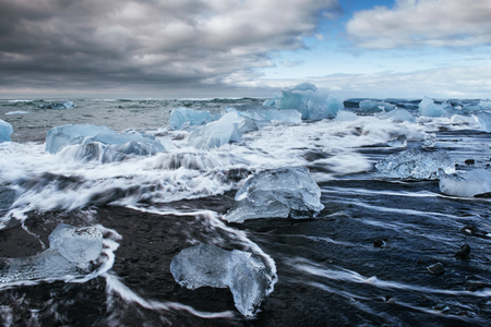 Jokulsarlon glacier lagoon, fantastic sunset on the black beach, Iceland.の写真素材