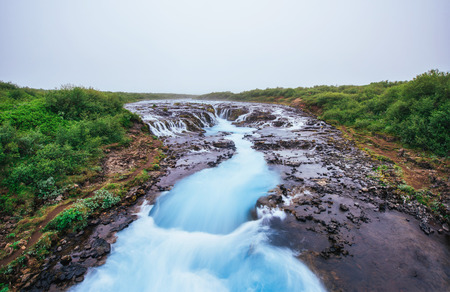 Fantastic landscape of mountains and waterfalls in Iceland.の写真素材