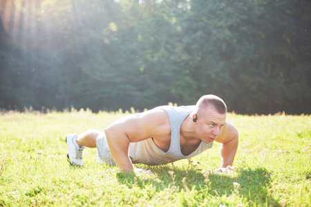 A young sportsman getting ready for athletic and fitness training outdoors. Sport, exercise,...