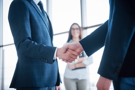 Two confident business man shaking hands during a meeting in the office, success, dealing, greeting and partner concept.の写真素材