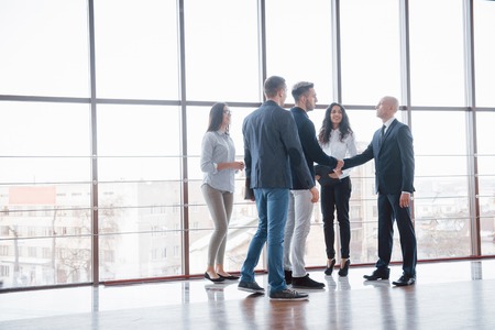 Two confident business man shaking hands during a meeting in the office, success, dealing, greeting and partner concept.の写真素材