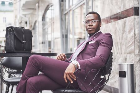Young businessman with a briefcase near a beautiful office. Business meeting.の写真素材
