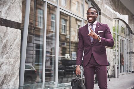 Portrait of a young beautiful African American businessman with a briefcase. Business meetingの写真素材