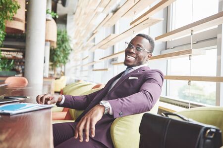 A young businessman signs a contract in a conference room.の写真素材