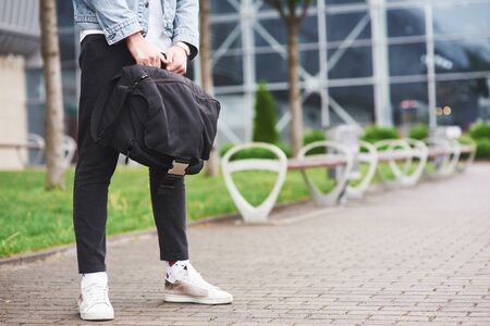A young man is waiting for a passenger at the airportの写真素材