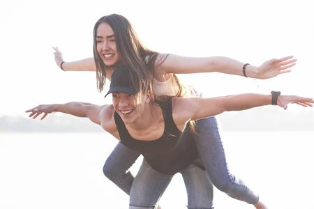 Happy friends have fun on the beach - Young people playing in open air water on summer holidays.の写真素材