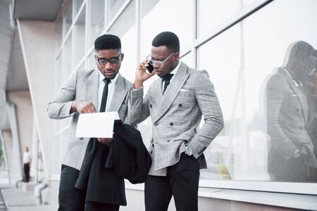 Business communication. Two cheerful business men talking to each other and discussing a project.の写真素材