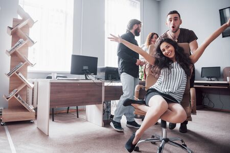A group of business people having fun, at the office. Celebrate a successful contract.の写真素材