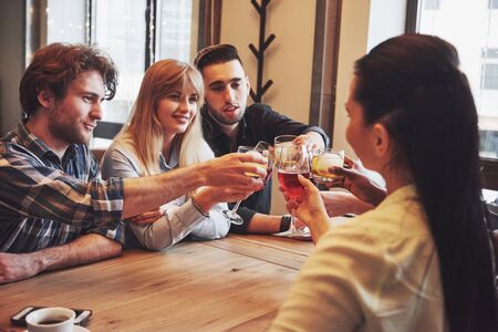 Hands of people with glasses of whiskey or wine, celebrating and toasting in honor of the wedding or other celebration.の写真素材