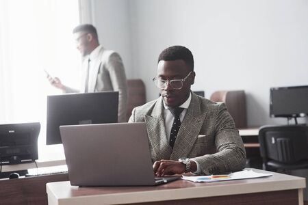 Image of african american businessman working on his laptop.の写真素材