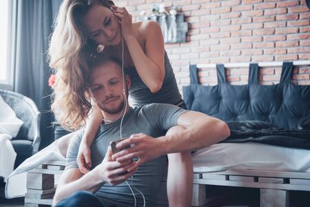 Attractive young lovers have a couple playing together in bedの写真素材