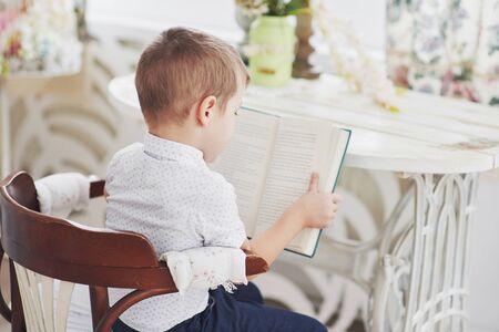 Boy reading a book. Getting ready for school.の写真素材