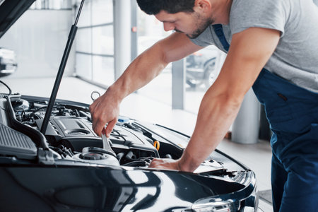 Auto mechanic working in garage. Repair service
