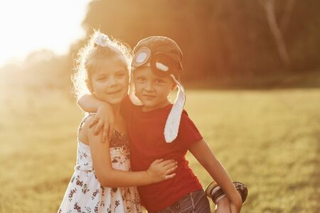 Pure happiness. Photo of dad with his daughter at beautiful grass and woods at background.の写真素材