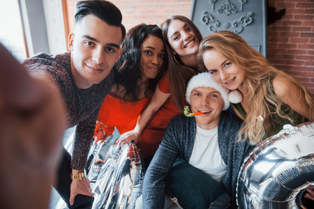Beautiful young friends, having fun on New Years Eve, holding numbers for 2020