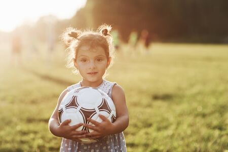 Posing for portrait. Adorable little kid loves soccer and all that is connected to it.の写真素材