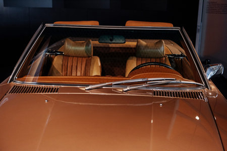 Front, close up view of beige retro cabriolet car leather interior and shiny hood: steering wheel,...