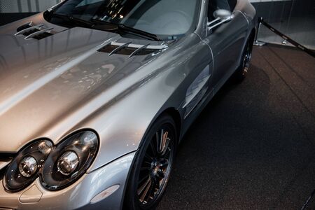 View from the top on modern grey cabriolet car with left dual headlight light, mirror, windshield wipers and light alloy wheelsの写真素材