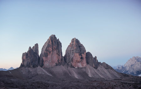 Three peaks Tre Cime mountains in the morning with clear sky over it.