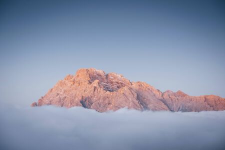 The peaks of the mountains stifle from a going thick fog. Unbelievable photo takes.の写真素材