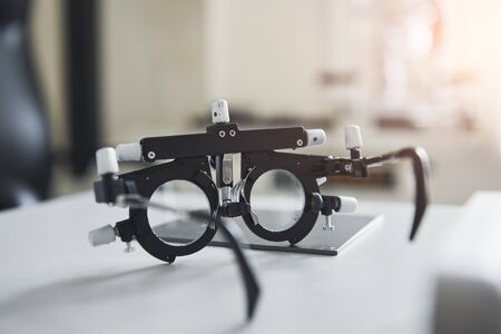 Special ophthalmologist device on the table in beautiful white room.の写真素材