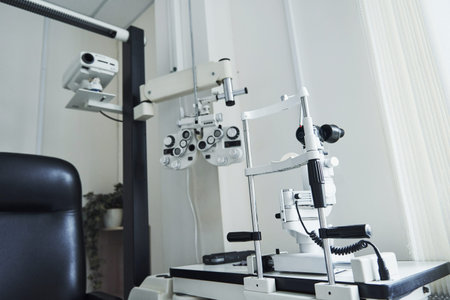 Ophthalmologist devices in the beautiful white room. Plant at background.