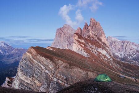 Green tent standing on the hill. Awesome place in the alpes of Seceda.の写真素材