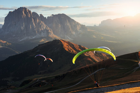 Breathtaking spectacle. Many of paragliders flying over the Seceda dolomites mountains in the...