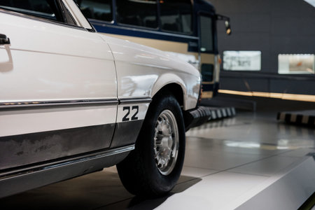 Cropped image of white classic rare car parked indoor on the tile.