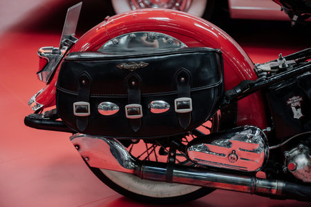 SINSHEIM, GERMANY - OCTOBER 16, 2018: Technik Museum. Black bag on the red rear wheel of bike that stands on the vehicle show.のeditorial素材